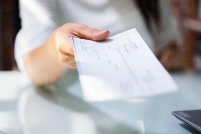 hand giving payroll compensation paycheck (1)